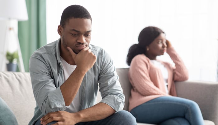 black-couple-young-man-and-woman-having-relationships-crisis-sitting-on-couch-and-looking-aside